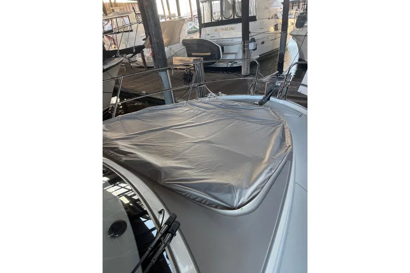  Yacht Photos Pics 2025 Beneteau Antares 11 Fly yacht with covered deck, docked in marina.