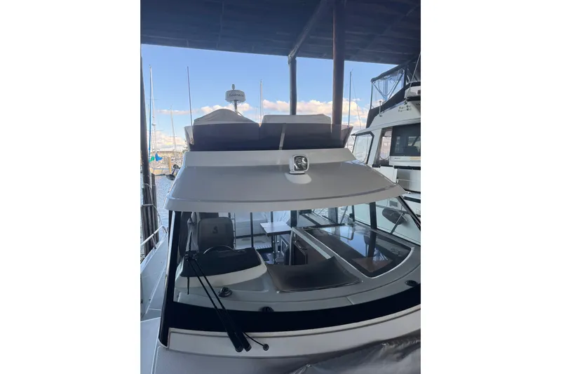  Yacht Photos Pics 2025 Beneteau Antares 11 Fly yacht docked, showcasing sleek design and modern features.