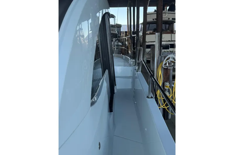  Yacht Photos Pics 2025 Beneteau Antares 11 Fly yacht side deck with railing and dock view.