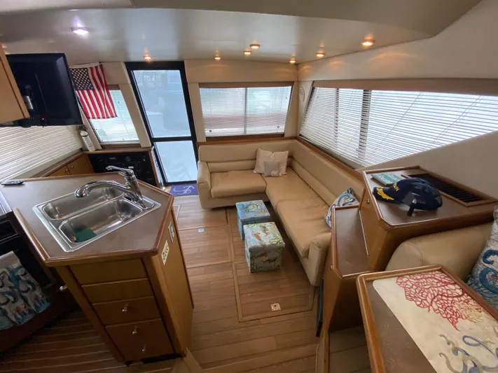  Yacht Photos Pics Interior of 2001 Bayliner 3988 yacht with cozy seating and kitchen area.