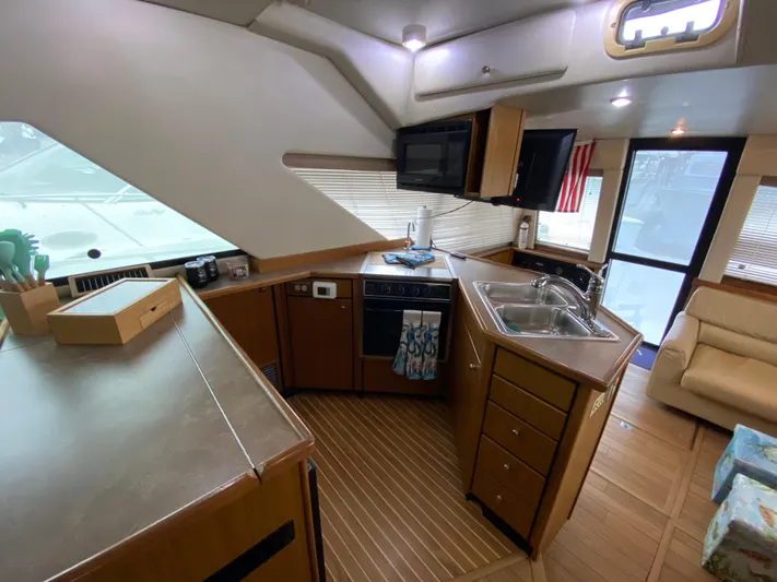  Yacht Photos Pics Interior of 2001 Bayliner 3988 yacht, featuring a modern kitchen with wood cabinetry.
