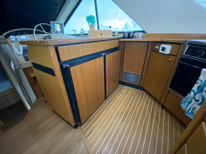  Yacht Photos Pics Interior of 2001 Bayliner 3988 yacht with wooden cabinetry and modern appliances.