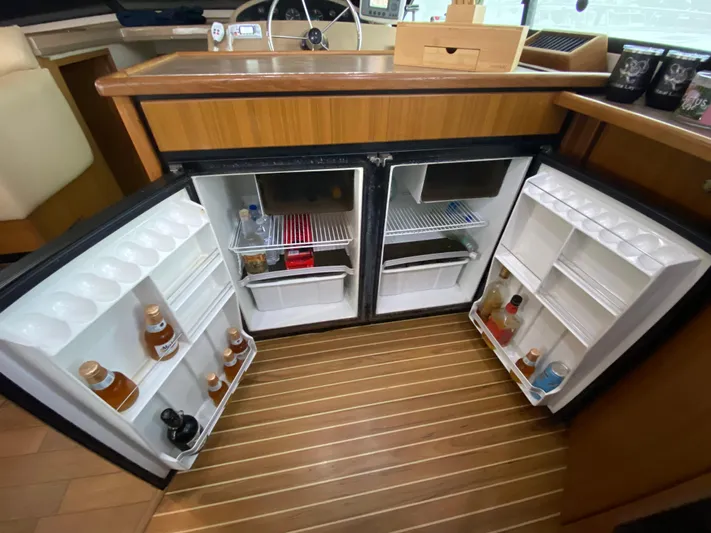  Yacht Photos Pics 2001 Bayliner 3988 yacht kitchen with open dual refrigerators, showcasing organized storage.