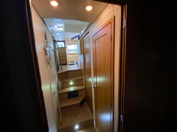  Yacht Photos Pics Interior view of 2001 Bayliner 3988 yacht, featuring wooden stairs and cozy lighting.