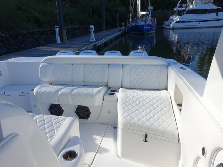  Yacht Photos Pics 2014 Cigarette 42 Huntress boat with white quilted seating at a marina.