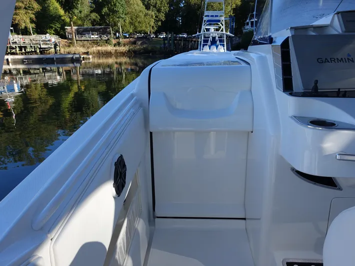  Yacht Photos Pics 2014 Cigarette 42 Huntress boat deck with Garmin equipment, docked by a serene waterfront.