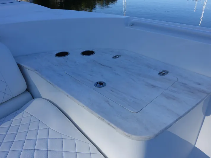  Yacht Photos Pics 2014 Cigarette 42 Huntress boat interior with white seating and table.