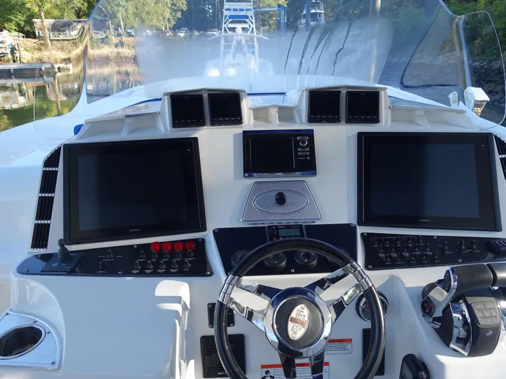  Yacht Photos Pics 2014 Cigarette 42 Huntress boat dashboard with dual screens and steering wheel.