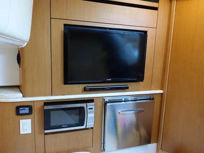  Yacht Photos Pics 2014 Cigarette 42 Huntress interior with TV, microwave, and mini-fridge.