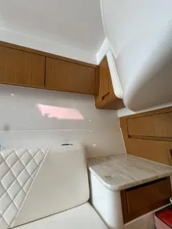  Yacht Photos Pics Interior of 2014 Cigarette 42 Huntress with wood cabinets and white seating.