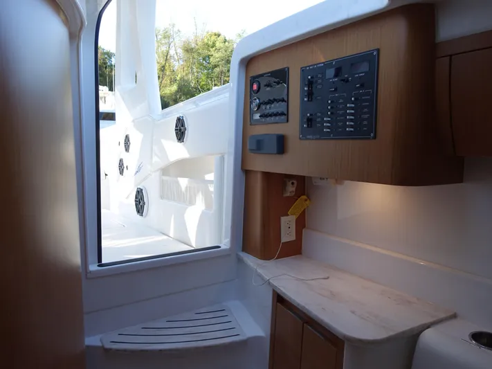 Yacht Photos Pics Interior of 2014 Cigarette 42 Huntress boat with control panel and seating area.