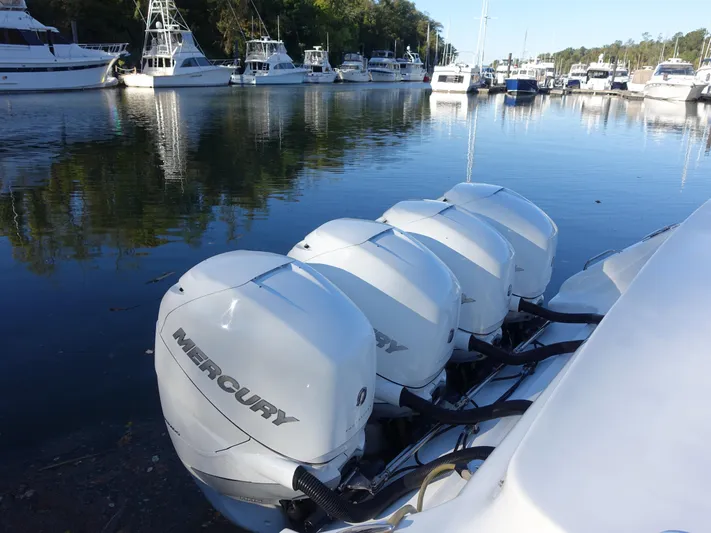  Yacht Photos Pics 2014 Cigarette 42 Huntress with four Mercury outboard engines docked in a marina.