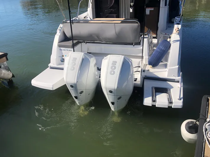  Yacht Photos Pics 2022 Beneteau Antares 9 with twin 200 HP outboard engines, docked on calm water.