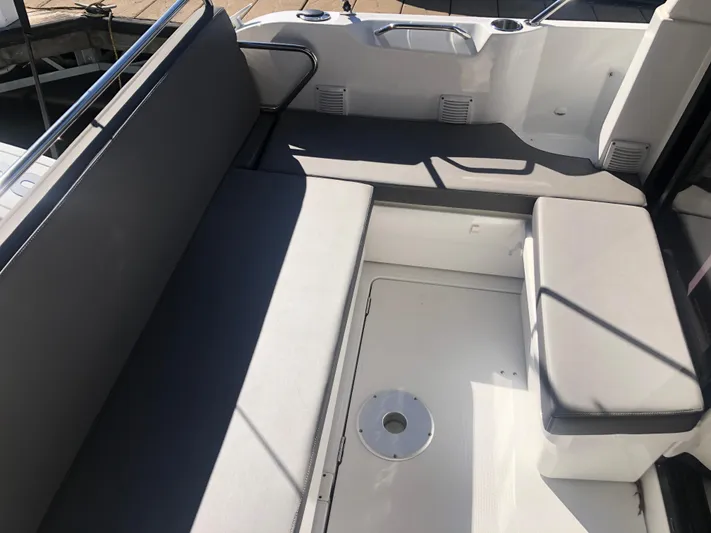  Yacht Photos Pics 2022 Beneteau Antares 9 boat interior with cushioned seating and sleek design.