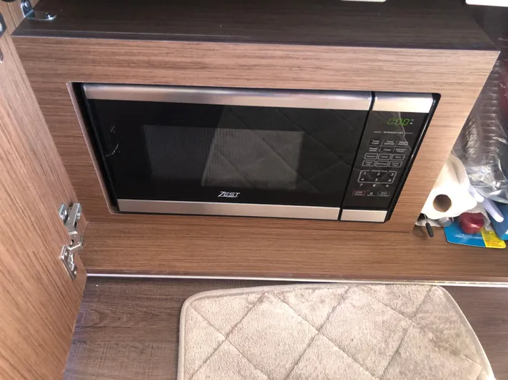 Yacht Photos Pics Microwave in 2022 Beneteau Antares 9 boat interior, wooden cabinetry.