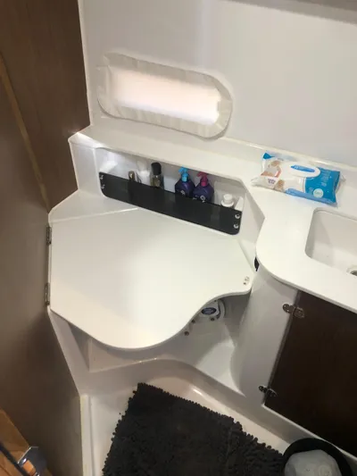  Yacht Photos Pics Bathroom interior of 2022 Beneteau Antares 9 boat, featuring sink and toiletries.