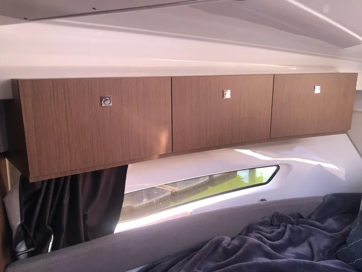  Yacht Photos Pics Interior of 2022 Beneteau Antares 9 with wooden cabinets and window view.