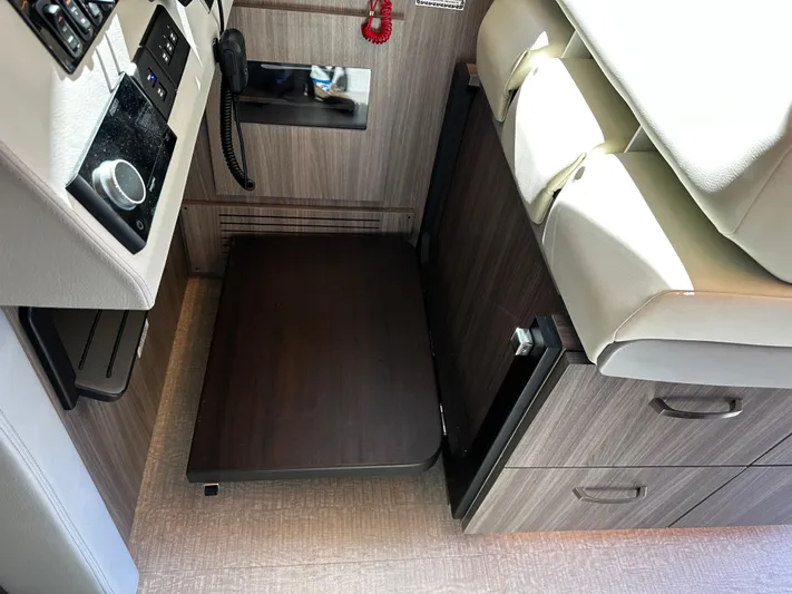 Fully Vested Yacht Photos Pics Interior of 2022 Regal 42 FXO boat with wooden cabinetry and seating.