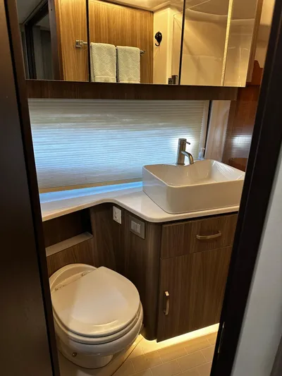 Fully Vested Yacht Photos Pics Luxurious bathroom in 2022 Regal 42 FXO yacht with modern fixtures and wood accents.