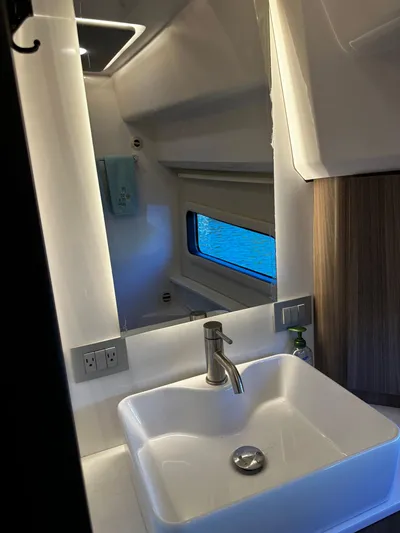 Fully Vested Yacht Photos Pics 2022 Regal 42 FXO bathroom with modern sink and window.