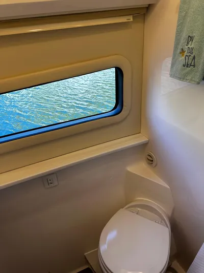 Fully Vested Yacht Photos Pics 2022 Regal 42 FXO yacht bathroom with window view of water.