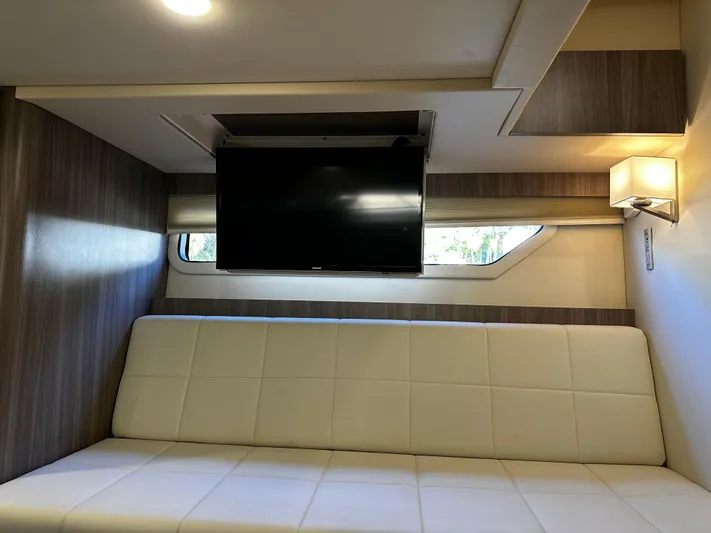 Fully Vested Yacht Photos Pics Interior of 2022 Regal 42 FXO yacht with sofa and wall-mounted TV.