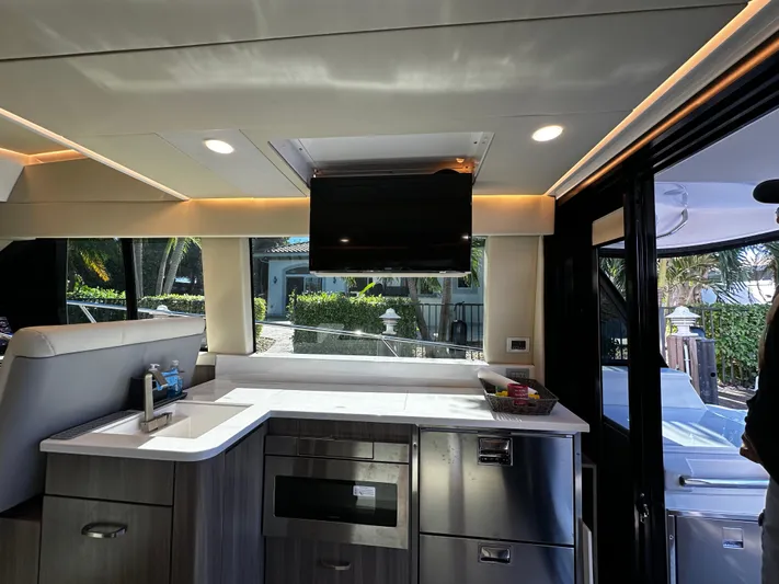 Fully Vested Yacht Photos Pics Interior of 2022 Regal 42 FXO yacht with modern kitchen and sleek design.
