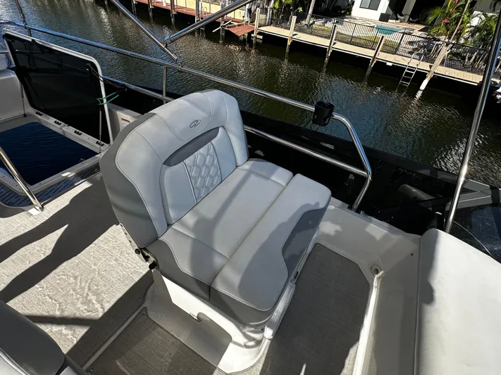 Fully Vested Yacht Photos Pics 2022 Regal 42 FXO boat seat with elegant design, dockside view.