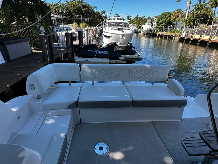 Fully Vested Yacht Photos Pics 2022 Regal 42 FXO yacht interior with plush seating at a marina.