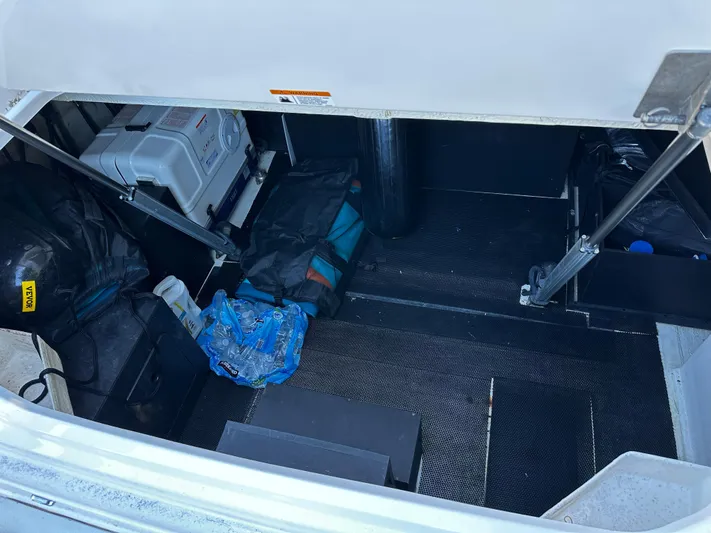 Fully Vested Yacht Photos Pics Storage compartment of 2022 Regal 42 FXO boat with various equipment and gear.