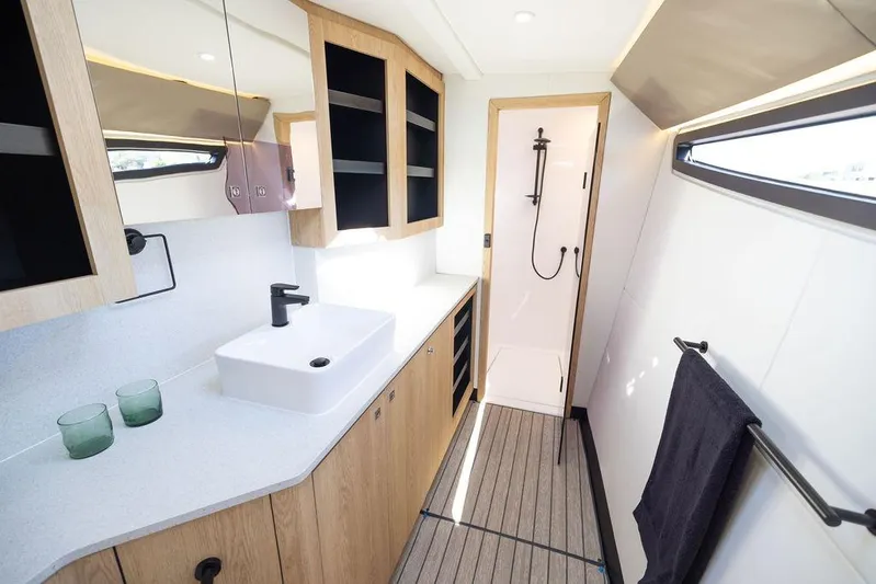  Yacht Photos Pics Modern bathroom interior of Introductory Cure Marine 55 yacht, 2025 model, featuring sleek design.