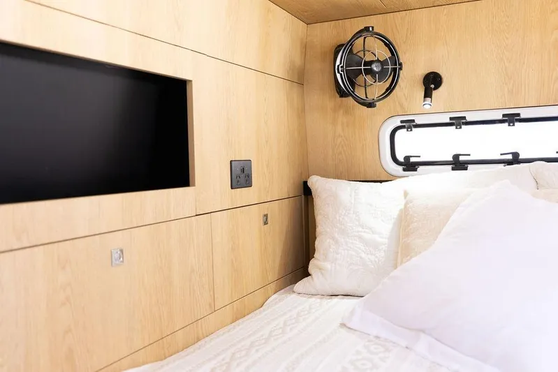  Yacht Photos Pics Interior of 2025 Introductory Cure Marine 55, featuring cozy bedding and modern amenities.