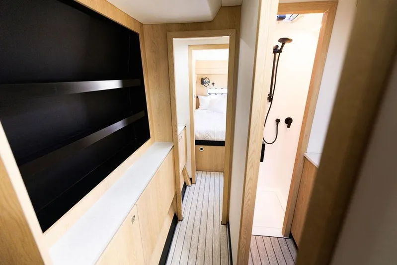  Yacht Photos Pics Modern interior of 2025 Introductory Cure Marine 55 yacht, featuring sleek wood finishes.