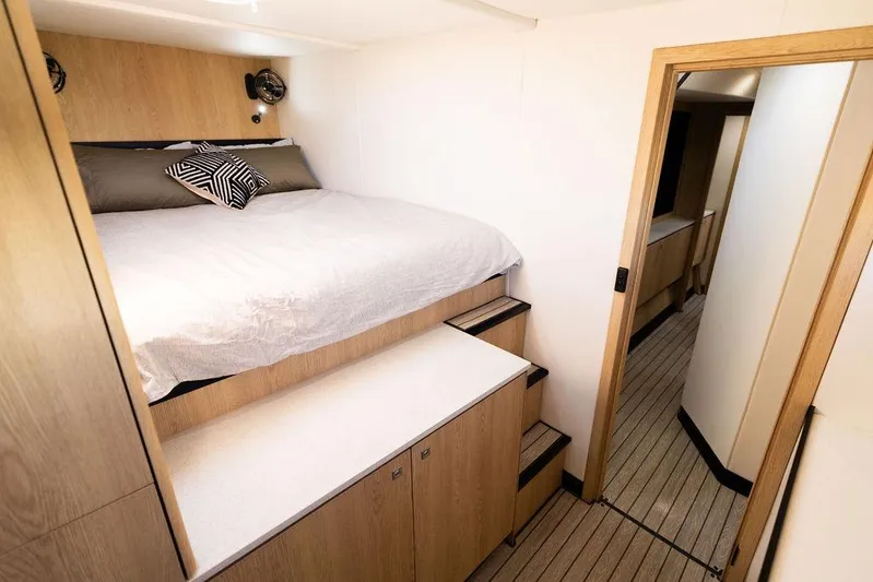  Yacht Photos Pics Modern bedroom interior in 2025 Introductory Cure Marine 55 yacht, featuring wooden accents and cozy bedding.