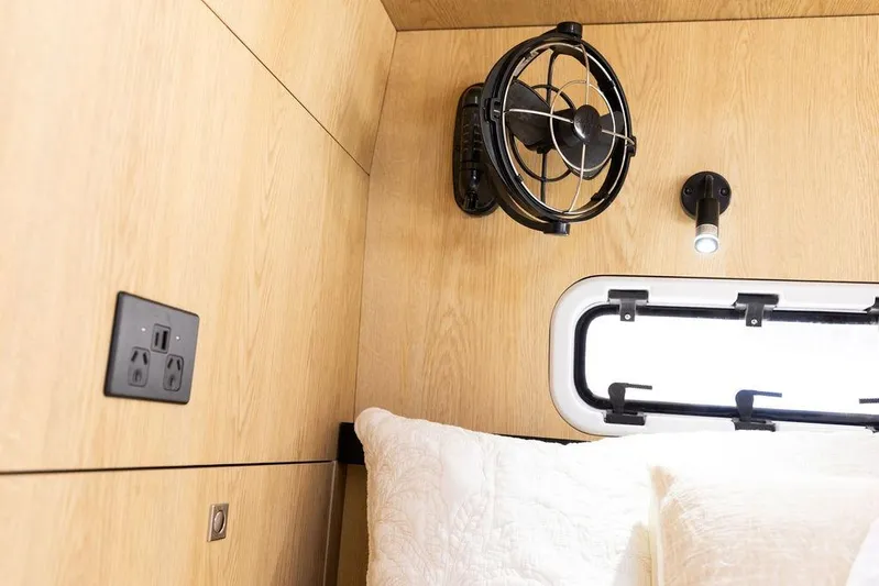  Yacht Photos Pics Interior of 2025 Introductory Cure Marine 55 with fan, light, and power outlet.