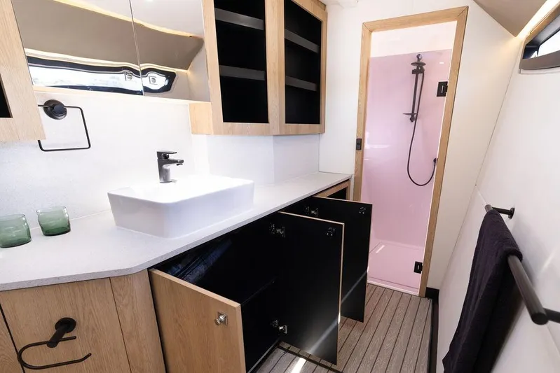  Yacht Photos Pics Modern bathroom in Introductory Cure Marine 55 yacht, featuring sleek design and pink shower, 2025 model.