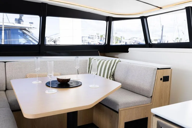  Yacht Photos Pics Modern interior of 2025 Introductory Cure Marine 55 yacht with elegant dining area.