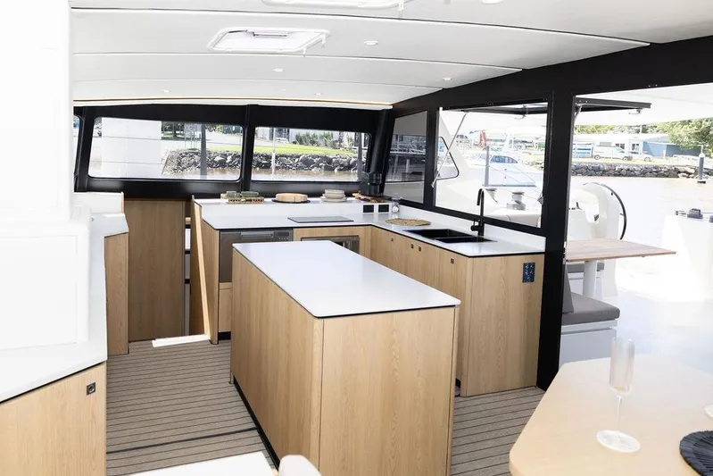  Yacht Photos Pics Modern kitchen interior of 2025 Introductory Cure Marine 55 yacht, featuring sleek design and ample windows.