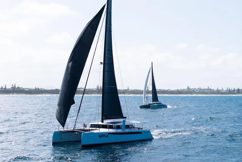  Yacht Photos Pics Sailing catamarans on ocean, Introductory Cure Marine 55, 2025 model, with black sails.