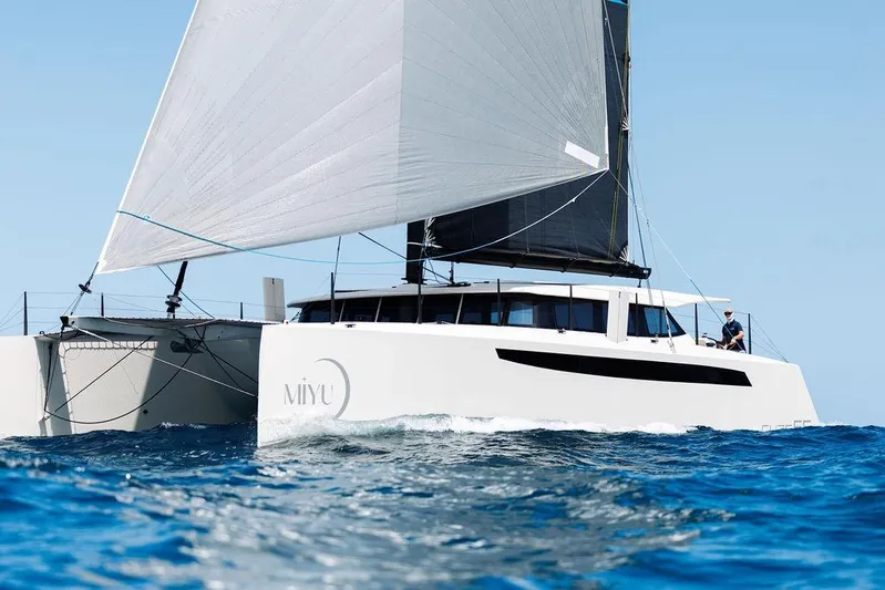  Yacht Photos Pics Sleek 2025 Introductory Cure Marine 55 catamaran sailing on open sea.