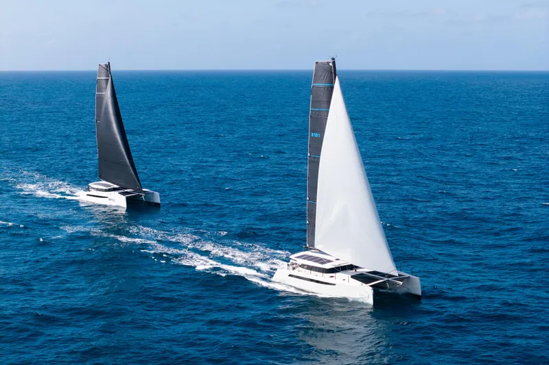  Yacht Photos Pics Two Cure Marine 55 catamarans sailing on open ocean, 2025 model.