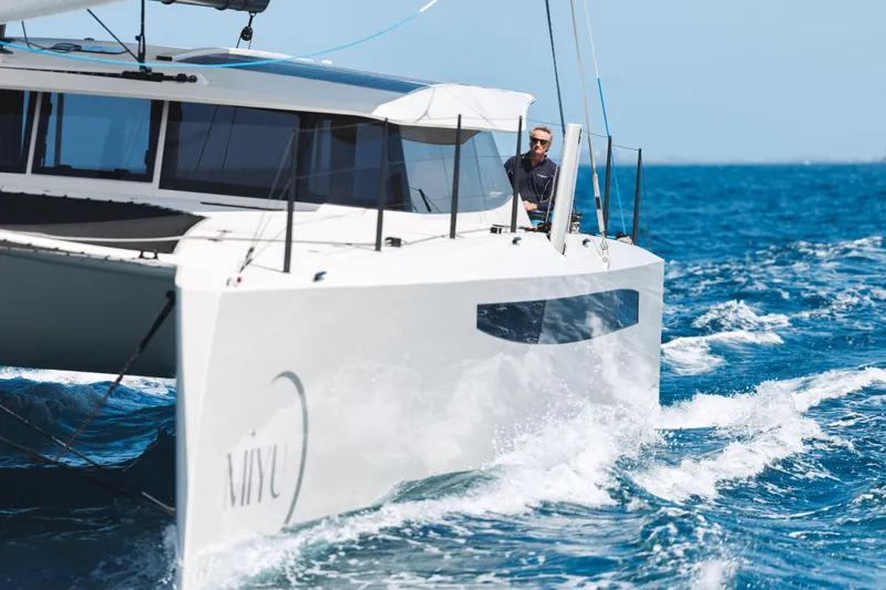  Yacht Photos Pics Sleek 2025 Introductory Cure Marine 55 catamaran sailing on open blue sea.