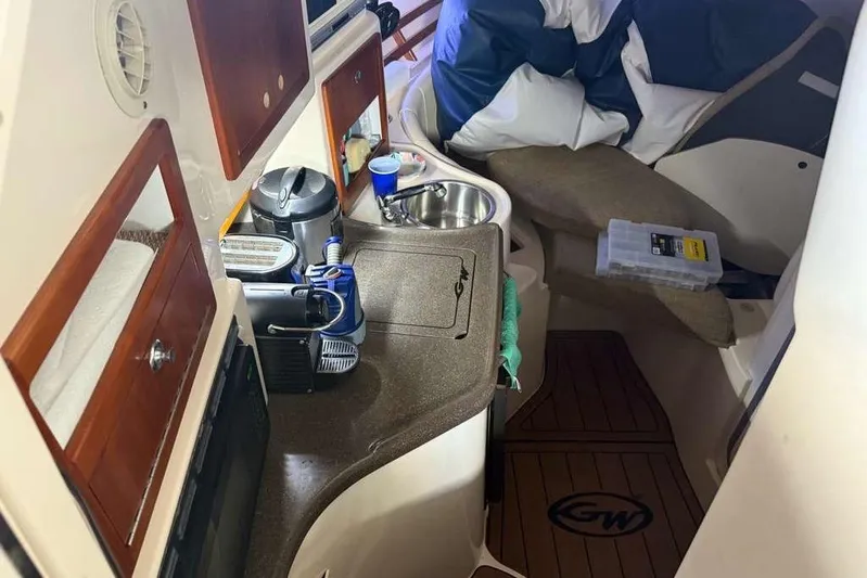  Yacht Photos Pics 2007 Grady-White Express 305 cabin interior with kitchenette and seating area.