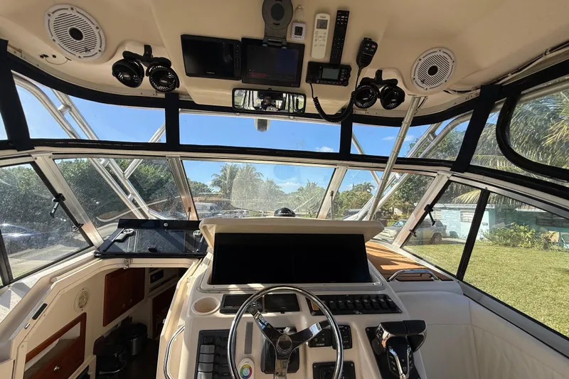  Yacht Photos Pics Interior view of 2007 Grady-White Express 305 boat cockpit with steering wheel and controls.