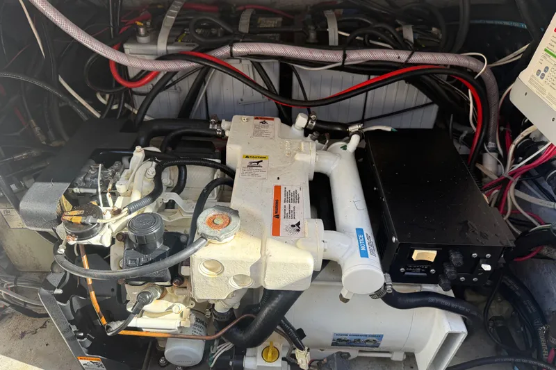  Yacht Photos Pics Engine compartment of a 2007 Grady-White Express 305 boat, showing detailed machinery and wiring.