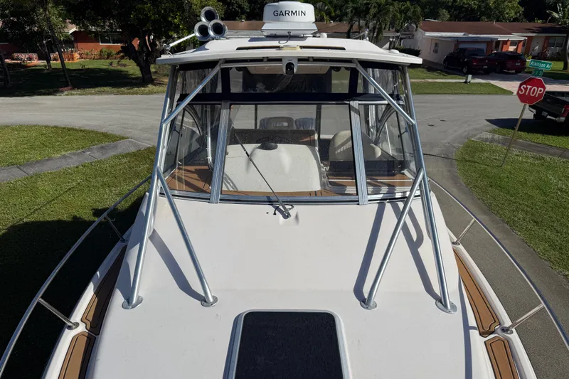  Yacht Photos Pics 2007 Grady-White Express 305 boat with Garmin equipment, parked on a residential street.