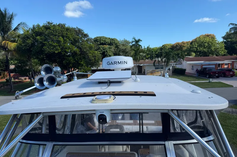  Yacht Photos Pics 2007 Grady-White Express 305 boat with Garmin radar, parked in a residential area.