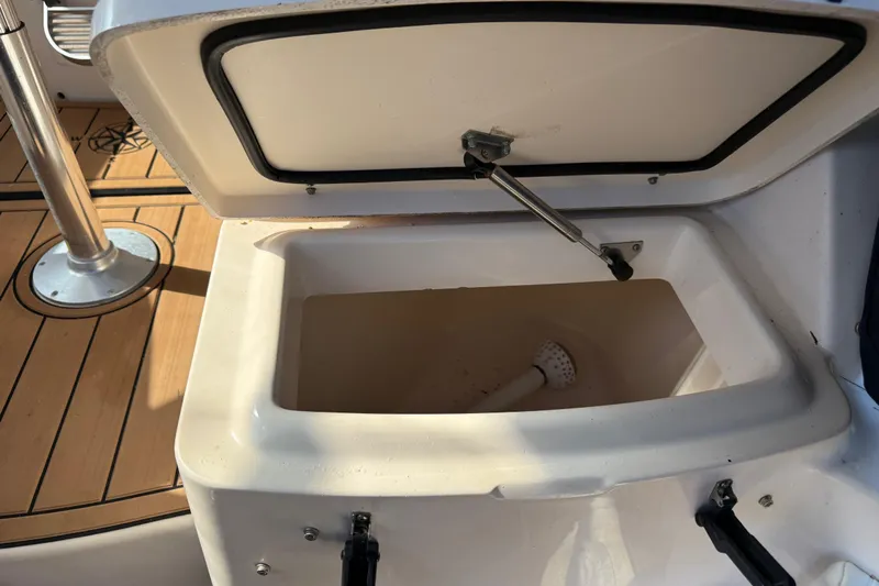  Yacht Photos Pics Open storage compartment on 2007 Grady-White Express 305 boat, featuring teak flooring.