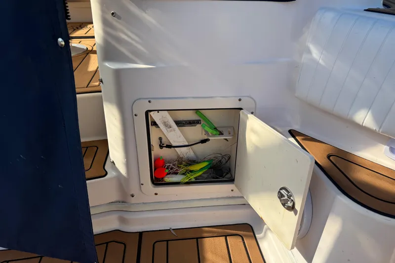  Yacht Photos Pics Open storage compartment on 2007 Grady-White Express 305 boat with fishing gear inside.