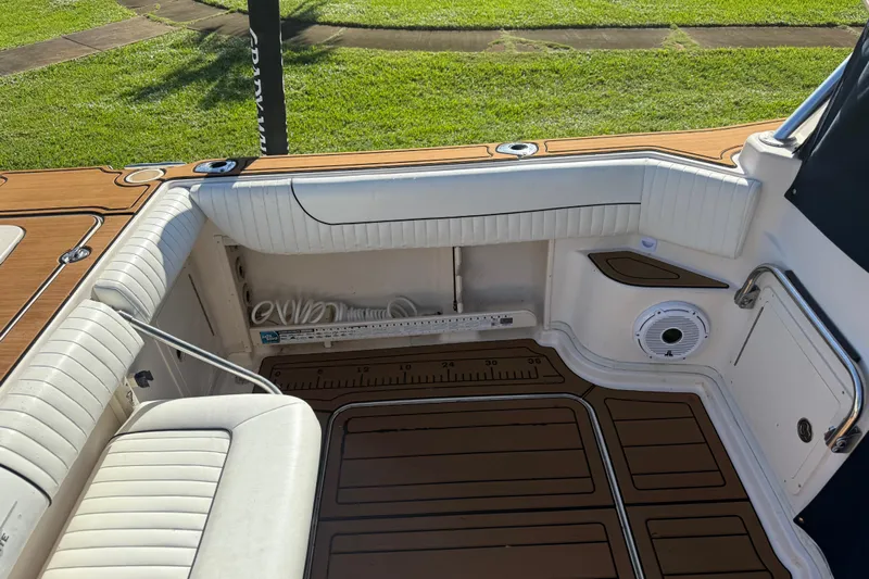  Yacht Photos Pics 2007 Grady-White Express 305 boat interior with cushioned seating and teak flooring.